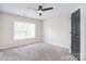Bedroom featuring gray carpet, a ceiling fan, and a window for natural light at 1811 Robbins Meadows Dr, Waxhaw, NC 28173