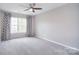 Cozy bedroom with soft carpet, modern curtains, and a bright window at 1811 Robbins Meadows Dr, Waxhaw, NC 28173