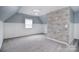 Bedroom with a window and gray brick accent wall, providing natural light at 1811 Robbins Meadows Dr, Waxhaw, NC 28173