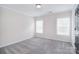 Bright bedroom featuring two windows and neutral colored walls and carpeting at 1811 Robbins Meadows Dr, Waxhaw, NC 28173