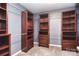 Walk-in closet featuring custom built-in shelves and drawers at 1811 Robbins Meadows Dr, Waxhaw, NC 28173