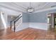 Spacious dining room featuring hardwood floors, modern lighting, and classic wainscoting for an inviting atmosphere at 1811 Robbins Meadows Dr, Waxhaw, NC 28173