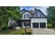 Charming two-story home with a well-maintained lawn, a two car garage, and traditional architectural details at 1811 Robbins Meadows Dr, Waxhaw, NC 28173
