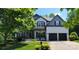 Charming two-story home featuring a two-car garage and well-manicured lawn and professionally landscaped front yard at 1811 Robbins Meadows Dr, Waxhaw, NC 28173