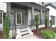 Inviting front porch with elegant iron railings and manicured landscaping, offering a welcoming entrance to the home at 1811 Robbins Meadows Dr, Waxhaw, NC 28173