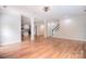 Spacious living room with wood floors that connects to the kitchen, perfect for entertaining at 1811 Robbins Meadows Dr, Waxhaw, NC 28173