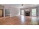 Inviting living room features a fireplace, wood floors, and an open layout with abundant natural light at 1811 Robbins Meadows Dr, Waxhaw, NC 28173