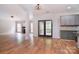 Open living space with hardwood floors, fireplace, and access to a deck offering a view of the outdoors at 1811 Robbins Meadows Dr, Waxhaw, NC 28173