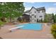 Inviting backyard pool area with a diving board, landscaping, and a spacious patio, perfect for outdoor relaxation at 1811 Robbins Meadows Dr, Waxhaw, NC 28173