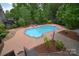 Aerial view of the backyard showing the large pool, patio, and lush landscaping at 1811 Robbins Meadows Dr, Waxhaw, NC 28173