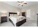Spacious bedroom with dark wood furniture and ceiling fan, with ensuite bathroom access at 1870 Beth Haven Church Rd, Denver, NC 28037