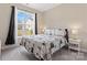 Bedroom with large window, patterned bedding, side tables, and modern decor at 1870 Beth Haven Church Rd, Denver, NC 28037