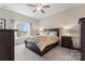 Bedroom with dark wood furniture, a ceiling fan, and a bright window view at 1870 Beth Haven Church Rd, Denver, NC 28037