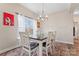 Dining room showcases a stylish chandelier, a black and white table, and a view of the outdoors at 1870 Beth Haven Church Rd, Denver, NC 28037