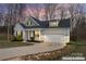 Charming single-Gathering home showcasing gray siding, black shutters, and an attached two-car garage at 1870 Beth Haven Church Rd, Denver, NC 28037