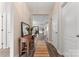 Bright foyer with hardwood floors, a wooden console table, and an open view into the living room at 1870 Beth Haven Church Rd, Denver, NC 28037
