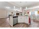 Open-concept kitchen features a granite island, stainless steel dishwasher, and modern pendant lighting at 1870 Beth Haven Church Rd, Denver, NC 28037