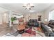 Spacious living room featuring hardwood floors, comfortable leather seating, and an open layout into the kitchen at 1870 Beth Haven Church Rd, Denver, NC 28037