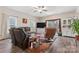 Bright and airy living room with hardwood floors, plush leather sofas, and large windows offering scenic views at 1870 Beth Haven Church Rd, Denver, NC 28037