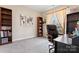 An office space featuring a desk, bookshelf, and natural light from a window at 1870 Beth Haven Church Rd, Denver, NC 28037