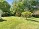 Lush backyard featuring a playground and pergola, providing ample space for outdoor activities and relaxation at 1927 S Wendover Rd, Charlotte, NC 28211