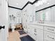 A modern bathroom with blue patterned wallpaper, a glass enclosed shower, and white vanity at 1927 S Wendover Rd, Charlotte, NC 28211