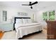 Bedroom featuring a large bed with a blue headboard, three accent pillows, and natural light at 1927 S Wendover Rd, Charlotte, NC 28211
