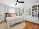 Bright bedroom with white walls, wood floors, built-in bookshelves, and a ceiling fan at 1927 S Wendover Rd, Charlotte, NC 28211