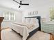 Bright bedroom featuring a large bed, hardwood floors, and natural lighting from two windows at 1927 S Wendover Rd, Charlotte, NC 28211