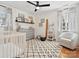 A Bedroom with stylish decor, hardwood floors, a white crib, and a black and white rug at 1927 S Wendover Rd, Charlotte, NC 28211