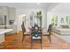 Inviting dining area featuring hardwood floors, modern chairs, and a glimpse of the living space at 1927 S Wendover Rd, Charlotte, NC 28211