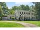 Charming two-story home with mature landscaping and a curved driveway on a lush green lawn at 1927 S Wendover Rd, Charlotte, NC 28211
