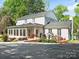 Spacious home exterior featuring a landscaped yard, back patio, sunroom, and well-maintained surroundings at 1927 S Wendover Rd, Charlotte, NC 28211
