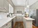 Beautiful kitchen with stainless steel appliances, custom cabinetry, quartz counters, and hardwood floors at 1927 S Wendover Rd, Charlotte, NC 28211