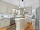 Bright kitchen featuring updated cabinets, stainless steel appliances, pendant lighting, and hardwood floors at 1927 S Wendover Rd, Charlotte, NC 28211