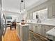 Modern kitchen with gray cabinetry, a center island, hardwood floors, and open to the living area at 1927 S Wendover Rd, Charlotte, NC 28211