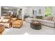 Comfortable living room with a cozy sofa, leather ottoman, and a sunlit atmosphere at 1927 S Wendover Rd, Charlotte, NC 28211