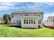 Back exterior view showcasing a large deck, a sunroom with many windows, and a well-maintained backyard at 1930 Southridge Dr, Belmont, NC 28012