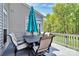 Outdoor seating area on a spacious deck, furnished with a table, chairs, and a large umbrella at 1930 Southridge Dr, Belmont, NC 28012