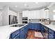 Open kitchen with two-tone cabinets, stainless steel appliances, and tile backsplash at 1930 Southridge Dr, Belmont, NC 28012