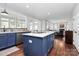 Open kitchen with kitchen island bar and view into dining room and living room at 1930 Southridge Dr, Belmont, NC 28012