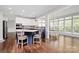 Kitchen island and dining area with hardwood floors and large windows at 1930 Southridge Dr, Belmont, NC 28012