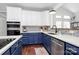 Modern kitchen featuring white and blue cabinetry with stainless steel appliances at 1930 Southridge Dr, Belmont, NC 28012
