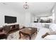 Spacious living room with a large TV, a comfortable sofa, and an open layout to the kitchen at 1930 Southridge Dr, Belmont, NC 28012