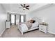 Airy main bedroom with a tray ceiling, carpet flooring, and a comfortable bed with decorative pillows at 1930 Southridge Dr, Belmont, NC 28012