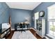 Stylish office space featuring blue walls, hardwood floors, and airplane themed decor at 1930 Southridge Dr, Belmont, NC 28012
