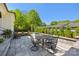 Backyard stone patio with outdoor seating and dining area, surrounded by lush landscaping at 1976 Ferncliff Rd, Charlotte, NC 28211