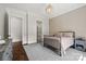Well-lit bedroom showcasing a grid patterned accent wall and a decorative pendant light at 1976 Ferncliff Rd, Charlotte, NC 28211