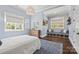 Serene blue bedroom with large windows, natural light, and custom storage at 1976 Ferncliff Rd, Charlotte, NC 28211