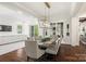 Bright dining room featuring modern lighting, hardwood floors, and views of the backyard at 1976 Ferncliff Rd, Charlotte, NC 28211
